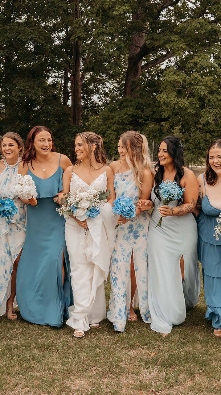 A row of bridesmaids in blue dresses
