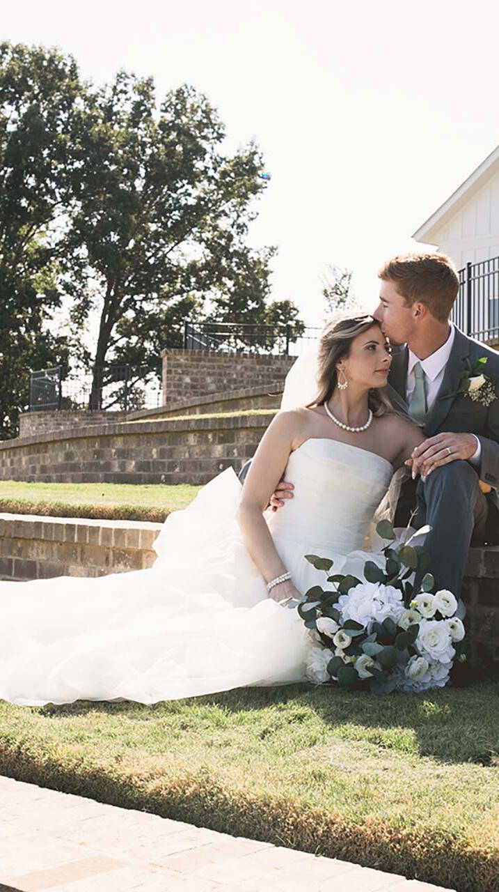 Wedding couple sitting on steps outdoors