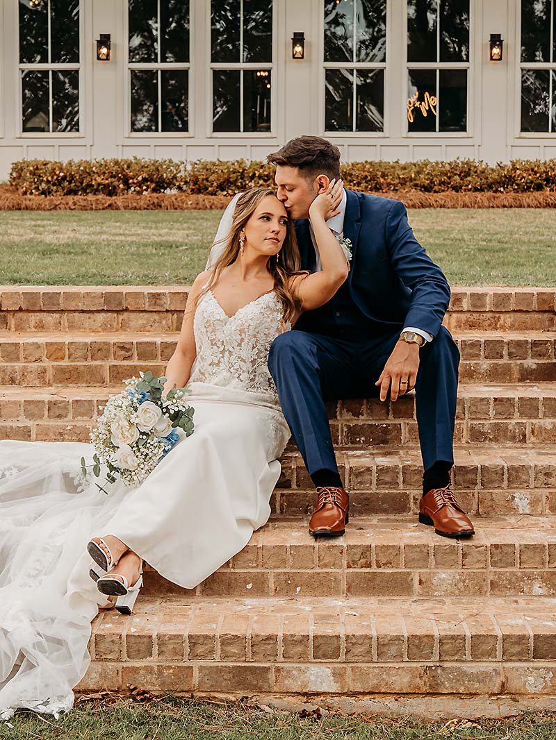 Wedding couple sitting on the stairs outdoors
