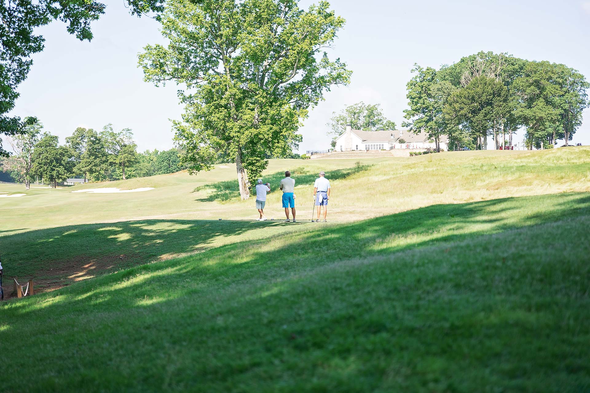 Three golfers on the course