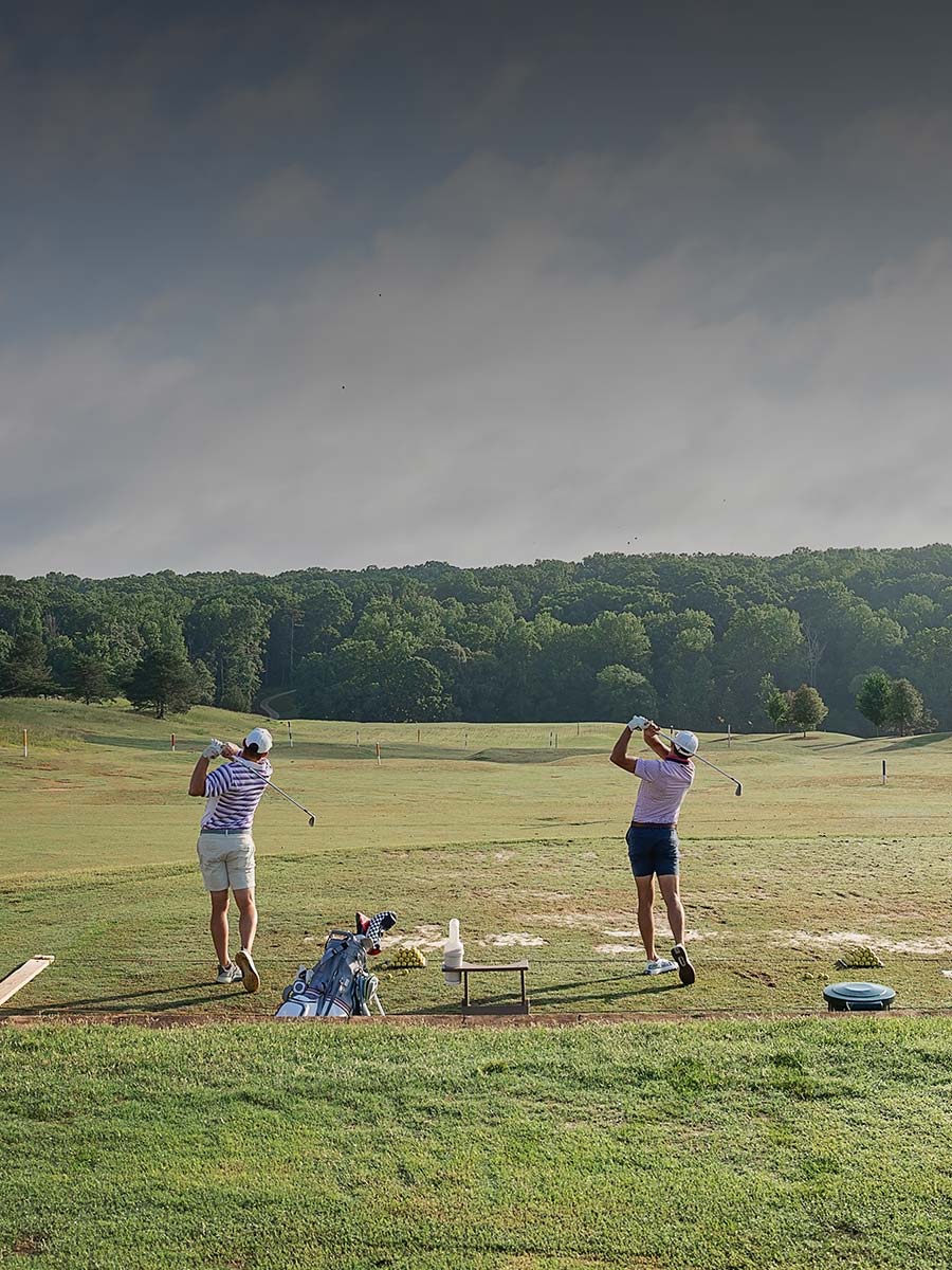 Two golfers on the driving range